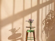 © valbar STUDIO/Stocksy - Vase With Flowers On Stool