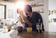 © ReeseArcurs/peopleimages.com - Couple, breakfast or eating cereal together at table with love, care or juice for fiber in meal in home. Romantic people, smile and healthy snack for bonding, nutrition and food in happy marriage
