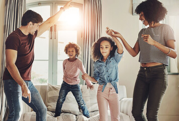 Canvas Print - Dancing, parents and children with love, support and care for trust, together or happiness in bonding. Family, woman and kids with man in play, connection and comfort on couch in home or living room