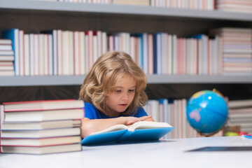 Fototapete - Thinking concentrate school kid. School pupil with pile of books. Children enjoying book story in school library. Kids imagination, interest to literature. Kids clever. Child study read book in class.
