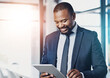 © peopleimages.com - Black man, smile and tablet for reading business email, communication and networking in office. African financial advisor, happy and fintech for online news, positive feedback and investment research