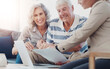 © ReeseArcurs/peopleimages.com - Paperwork, old couple and smile for retirement, laptop or financial advisor with senior people or planning. Happy, online and investment of fund, consulting or reading of payment in documents in home
