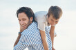 © Frank Coop/peopleimages.com - Man, happy and carrying on beach with boy, playful and laugh for travel, holiday and bonding as fun. Father, son and shoulder ride by ocean with support, love and care for trip, vacation and playing