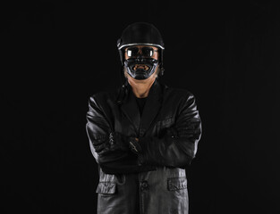 Portrait of a biker in a black helmet on a black background