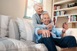 © Chanelle2000/peopleimages.com - Old couple, tablet and growth on banking app with smile or investment profit results in home. Happy woman, senior man and elderly people reading retirement savings, insurance policy or news update