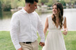 © Lea Jones/Stocksy - portrait  of young bride and groom by a lake