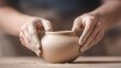© BoOm - A close-up of hands shaping a clay pot on a pottery wheel, showcasing the artistry and craftsmanship in ceramics.