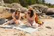 © Diego Martin/Stocksy - Couple of Friends Enjoying Beach Picnic with Fresh Food and Wine