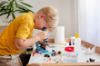 © Iryna Auhustsinovich/Stocksy - boy with   Microscope
