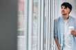 © carballo - young man with cup at home window