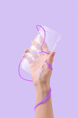 Hand of unrecognizable person holding transparent rectangular figure