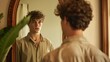 © A Denny Syahputra - A young man stands in front of a vintage mirror, looking contemplative in a warm, cozy room filled with natural light