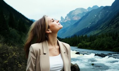 Wall Mural - Portrait of a beautiful woman in a beige jacket on the background of a mountain river