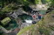© Daniel Zapata/Stocksy - Unrecognizable group of tourists at a waterfall.