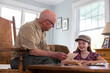 © Raymond Forbes LLC/Stocksy - Senior Citizen  Veteran grandfather photos with granddaughter