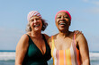 © BONNINSTUDIO/Stocksy - Senior women sharing laughter and joy at the beach