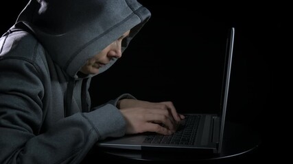 Lady spend free time by notebook. A woman with computer addiction pass her free time by her laptop in the dark room.