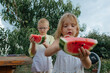 © Anna Artemenko/Stocksy - children holding watermelon slices