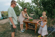 © Anna Artemenko/Stocksy - woman cutting watermelon for family