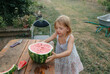 © Anna Artemenko/Stocksy - blonde girl with a big watermelon