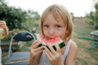 © Anna Artemenko/Stocksy - blonde girl with a slice of watermelon