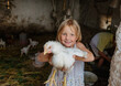 © Anna Artemenko/Stocksy - portrait of a girl with a chicken in her hands