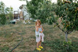 © Anna Artemenko/Stocksy - girl picking pears in the garden