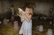 © Anna Artemenko/Stocksy - portrait of a girl with a chicken in her hands