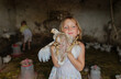 © Anna Artemenko/Stocksy - portrait of a girl with a chicken in her hands