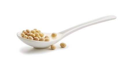 A spoon filled with soybeans on a white background, perfect for food and cooking concepts