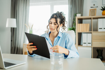 Wall Mural - Young caucasian business woman working in office on laptop