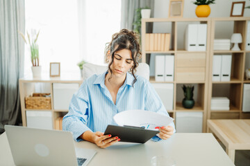 Wall Mural - Young caucasian business woman working in office on laptop