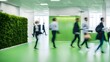 © Hastuti - people walking on green office space, motion blur effect, environment concept