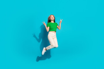 Poster - Full size photo of nice young girl jump show v-sign empty space wear t-shirt isolated on teal color background