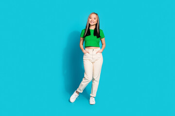 Wall Mural - Full size photo of nice young girl posing wear t-shirt isolated on teal color background