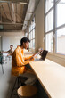 © Nuria Seguí/Stocksy - Businesswoman Working On Laptop In Modern Workplace