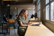 © Nuria Seguí/Stocksy - Female Entrepreneur Working On Laptop In Modern Workplace