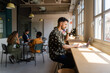 © Nuria Seguí/Stocksy - Male Entrepreneur Working On Laptop In Modern Workplace