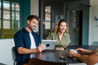 © Nuria Seguí/Stocksy - Businesspeople Using Digital Tablet In Modern Office