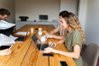 © Nuria Seguí/Stocksy - Teamwork Working On Laptop In Modern Office