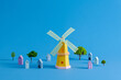 © Marc Tran/Stocksy - Colorful Paper Windmill With Houses And Trees