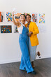© VICTOR TORRES/Stocksy - Friends capturing fun moments at an art gallery