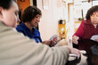 © María Soledad Kubat/Stocksy - Family Playing Cards In Kitchen