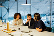 © BONNINSTUDIO/Stocksy - Business team having meeting analyzing financial data on laptop