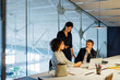 © BONNINSTUDIO/Stocksy - Business people having meeting around office desk