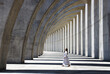 © Rene de Haan/Stocksy - woman walking in concrete construction