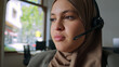© Guille Faingold/Stocksy - Woman wearing hijab with headset