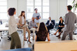 © BONNINSTUDIO/Stocksy - Group of businesspeople listening to their boss giving a presentation