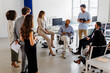 © BONNINSTUDIO/Stocksy - Diverse corporate business team having meeting in modern office