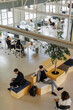 © BONNINSTUDIO/Stocksy - Business people working in a modern open plan office space